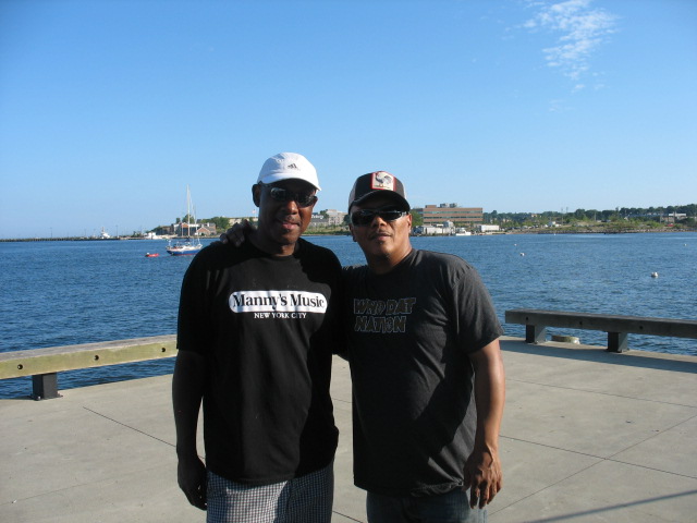 Andre with Ivan Neville by the water