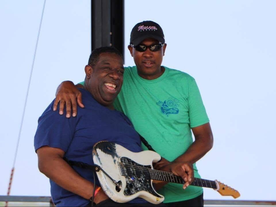 Andre performing with Rohn Lawrence on acoustic guitar