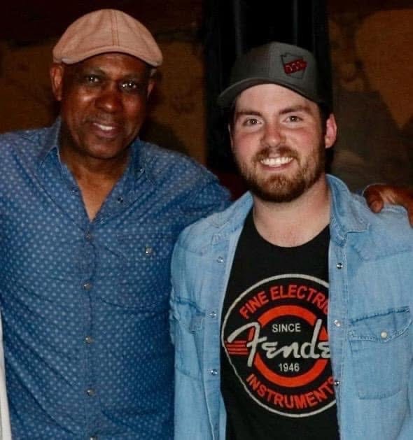 Andre with a friend wearing a Fine Electrical Instruments shirt